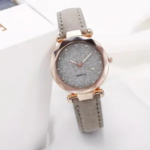 Close-up of women's quartz watch with grey glitter dial and frosted leather strap
