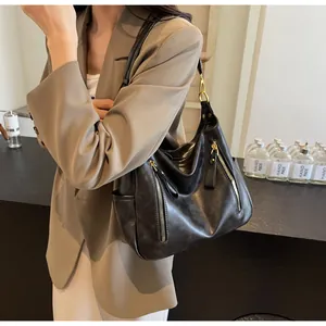 Detailed macro view of black retro tote bag with functional zippers
