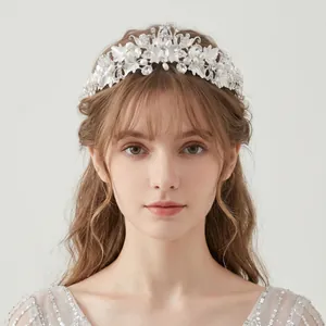 Close-up of elegant floral bridal tiara with pearls and crystals on model