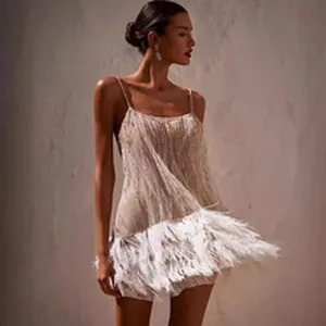 Detail shot of elegant mini dress with sequin bodice and feather hem decoration
