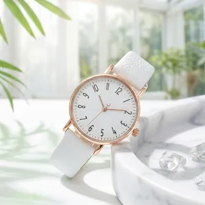 Close-up of elegant women's watch with white lychee leather strap and rose gold case