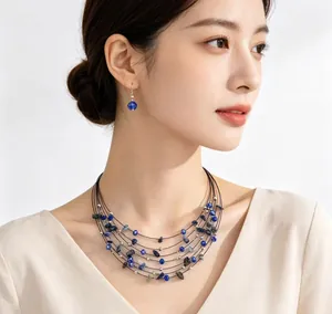 Bohemian multi-layered necklace and earring set with blue crushed stones for women.