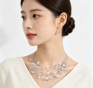 Close-up of Bohemian multi-layer crushed stone necklace and earrings on an Asian model.