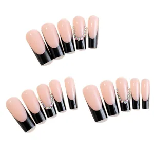 Elegant long coffin French tip press-on nails with black tips and sparkling rhinestones
