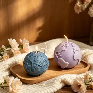 Detailed Earth and Moon shaped aromatherapy candles lit on a rustic wooden tray