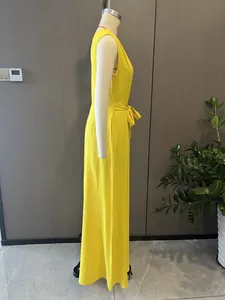 Side profile detail of elegant yellow sleeveless wide-leg jumpsuit with a waist tie