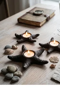 Detailed view of vintage cast iron starfish candle holders on a rustic wooden table with shells