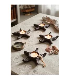 Detailed macro view of cast iron starfish candle holders in a nautical theme setting.