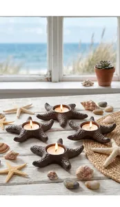 Vintage cast iron starfish candle holders set with shells on a rustic wooden table
