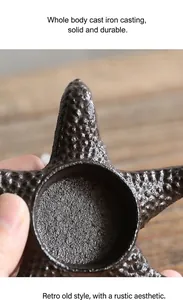 Detailed macro shot of vintage cast iron starfish candle holder showing rugged texture