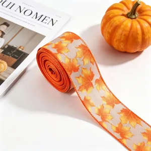Close-up of autumn maple leaf pattern printed on a rustic linen decorative ribbon