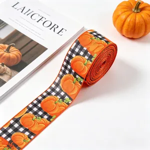 Close-up of autumn harvest ribbon with orange pumpkin and checkered pattern for DIY.