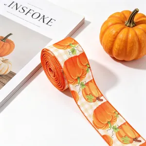 Close-up of autumn harvest festival ribbon with orange pumpkin prints on white background