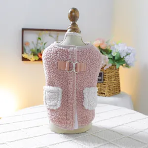 Detail view of pink fleece pet vest with white pockets and metal ring closure.