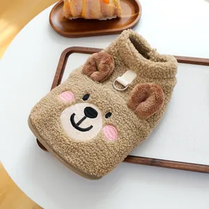 Detailed close-up of brown sherpa dog vest featuring a cute bear face and a metal D-ring