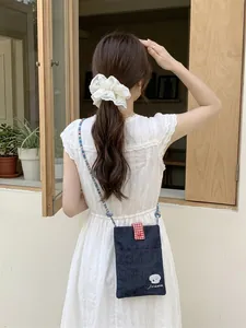 Cute embroidered denim crossbody bag for women with small dog pattern and red gingham flap