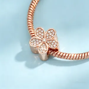 Close-up of rose gold cherry blossom charm with sparkling pavé crystals for DIY jewelry