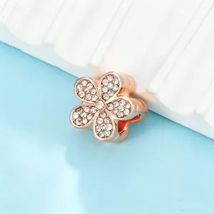 Close-up of sparkling rose gold flower charm with pavé crystals for DIY bracelets