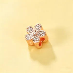 Detailed view of rose gold flower charm bead paved with sparkling crystals