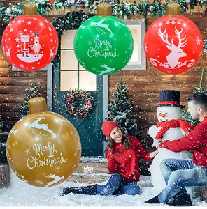 Large inflatable Christmas balls in red, green, and gold with festive Merry Christmas prints