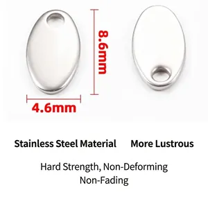 Detailed macro view of a stainless steel oval charm tag showing 8.6x4.6mm dimensions for DIY jewelry