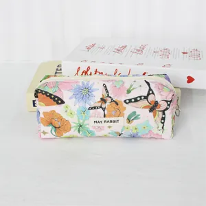 Detail shot showing the vintage floral print and corduroy texture of the multi-use pouch bag
