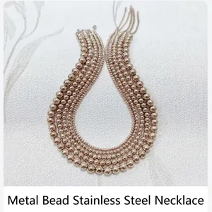 Macro detail of various sizes of 18K gold plated stainless steel smooth bead necklaces