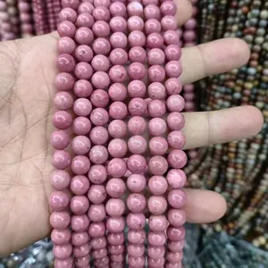 Primo piano di perle tonde in pietra naturale rodonite rosa da 8mm per la creazione di gioielli
