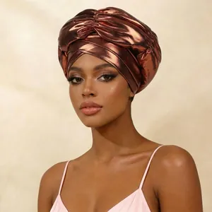Close-up of stylish bronze metallic headwrap with African-style cross-front knot.