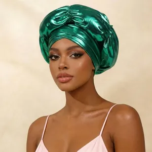 Shiny emerald green metallic turban headwrap featuring elegant front cross knot detail