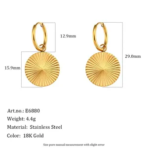 Gold-plated stainless steel hoop earrings featuring ribbed sunburst disc pendants