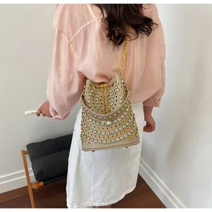 Vista posteriore di una donna che indossa un secchiello beige stile punk con borchie