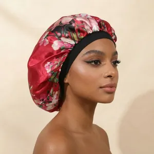 Close-up of a floral print satin sleep bonnet with a wide elastic black band