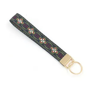 Porte-clés de poignet en tissu brodé de style ethnique avec motif floral et anneau doré