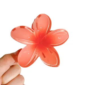 Red frangipani flower hair claw clip for elegant women's updo styles.