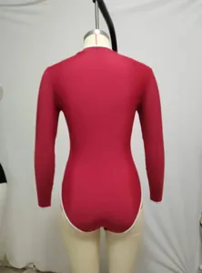 Back view of a burgundy long-sleeved athletic one-piece swimsuit with minimalist white trim