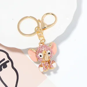 Detail shot of a sparkling pink rhinestone elephant keychain with gold-tone hardware