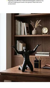 Detailed view of artistic black kneeling male figure sculpture on a home office desk