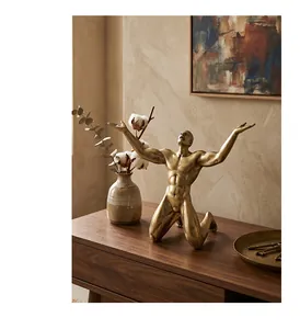 Detailed view of Nordic golden muscular male sculpture in warm home setting