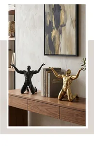Detailed view of Nordic male figurines in gold and black on a wooden console
