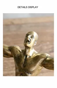 Close-up of the expressive facial detail and golden metallic texture of the retro sculpture