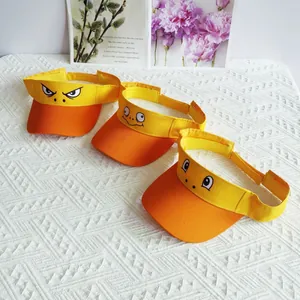 Detail view showing three yellow cartoon sun visor hats with funny eyes embroidery
