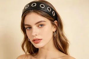 Close-up of black PU leather wide headband with silver metal hollow circles