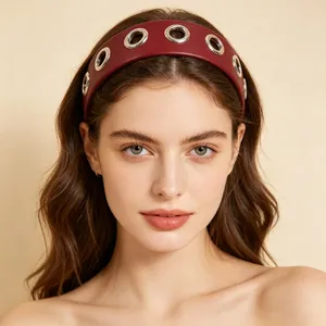 Fashionable burgundy wide PU leather headband with silver hollow eyelets on model