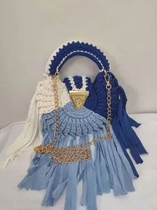 Handmade blue and white crochet shoulder bag featuring long tassels and gold chain
