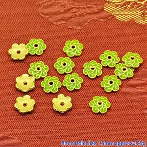 Close-up detail showing green enamel flower-shaped alloy bead caps for DIY jewelry making