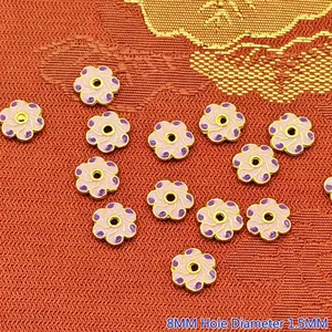 Macro view of 8mm pink and purple enamel flower spacer beads for DIY jewelry making crafts