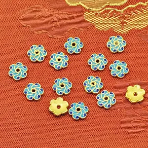 Detailed close-up of 8mm flower-shaped enamel bead caps for DIY jewelry making.
