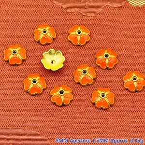 Detailed view of 9mm orange enamel flower bead caps for DIY jewelry making