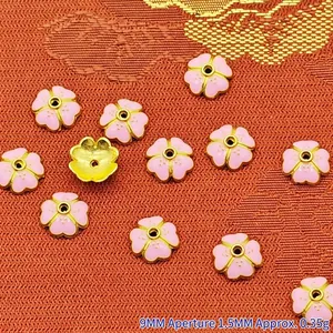 Detail view of 9mm pink enamel flower-shaped bead caps with 1.5mm aperture